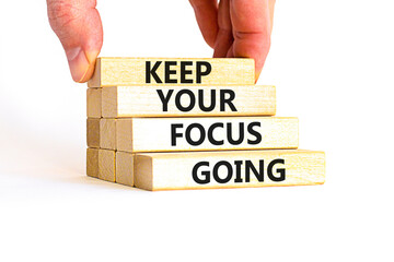 Keep your focus going symbol. Concept words Keep your focus going on beautiful wooden blocks. Beautiful white table white background. Business and keep your focus going concept. Copy space.