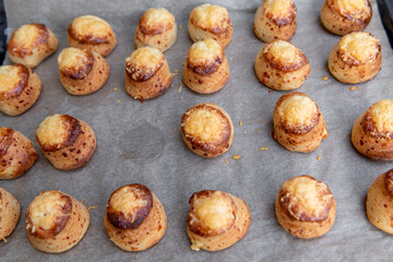 Pogaca stuffed with cheese. A full tray of fresh Pogaca, salty buns with cheese - Pogace.