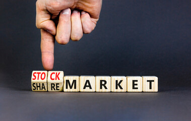 Stock or share market symbol. Concept words Stock market or Share market on beautiful wooden blocks. Beautiful grey background. Businessman hand. Business stock or share market concept. Copy space.