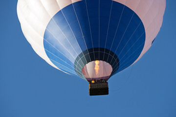 Fototapeta premium Flying colorful hot air balloon in the blue sky