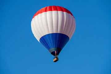 Fototapeta premium Flying colorful hot air balloon in the blue sky
