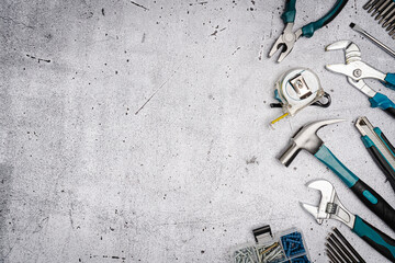 Set of tools on concrete background,