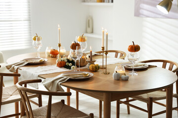 Stylish dining room with beautiful table setting and autumn decor