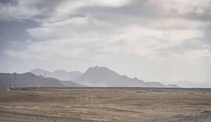 Minimalist silhouette of a mountain range in the highlands of the Tien Shan in the Pamirs in Tajikistan, panoramic landscape for the background with rocky mountains