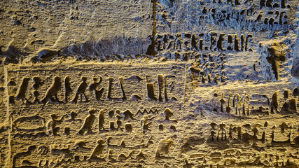 Egyptian hieroglyphs and paintings on the walls of Egyptian ancient temples
