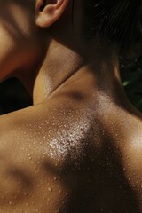 Fototapeta premium A close-up shot of a person's back with water droplets, great for illustrations about swimming, showering or bath time