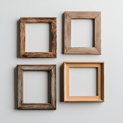 four empty wooden frames against a white wall