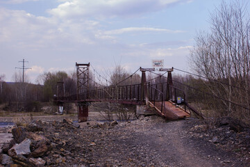 The old rusty metal bridge over the river. Russia, Moscow region