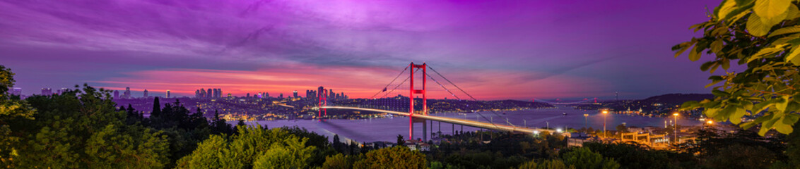 A breathtaking panoramic view of Istanbul at sunrise, showcasing the Bosphorus Bridge and the city skyline. Stunning Panoramic View of Istanbul at Sunrise over Bosphorus Bridge