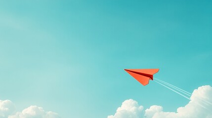 Fototapeta premium Red paper airplane flying in a blue sky