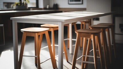 Modern white table with light wood stools in a bright office.