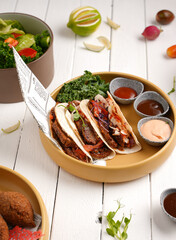 Beef taco, mexican food, Rustic Charm, Warm and muted colors.Mexican tacos with beef, tomatoes and onions. Side salads and sauces