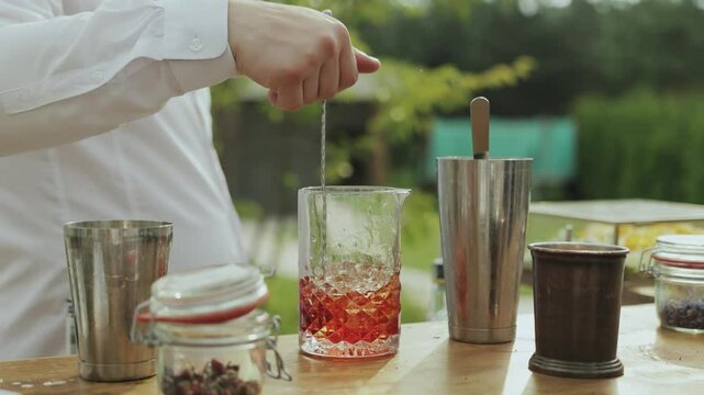 Crafting a Beautiful and Colorful Cocktail Outdoors Using Professional Bartending Techniques
