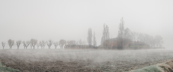 Rural house in the fog in the lower Po Valley; Mdicina municipality, Bologna Metropolitan city, Emilia-Romagna, Italy.