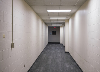 Dimly lit hallway to dark hallway