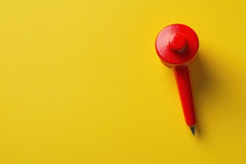 red push pin on yellow background