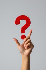 Hand holds red question mark. Seeking answers. Curiosity shown. Thinking about solutions. Possible research concept. Person pondering. Hand gestures. Intelligence represented. Clever person.