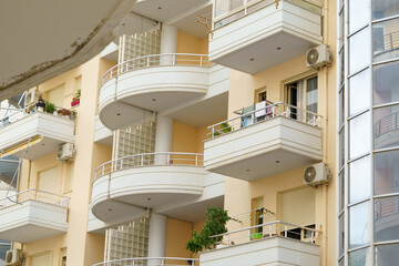 Fototapeta premium Modern minimalist apartment building in Mediterranean style with air conditioning in Albania on the sea coast. Concept of selling a house abroad, renting apartments