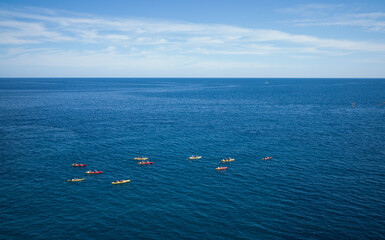 Aerial view of a group of kayaks in the sea.