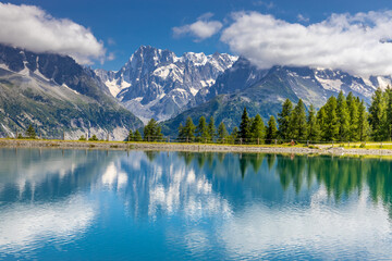 Fototapeta premium Lake in the Alps. Beautiful clear turquoise water lake in Chamonix Mont Blanc valley in French Alps. Alpine beautiful scenery in summer with blue sky