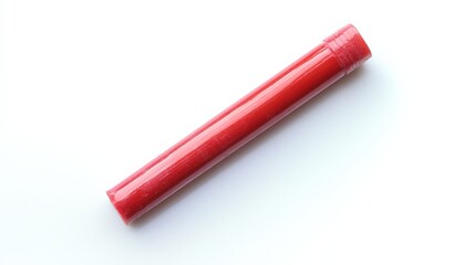 close up of a red crayon on a white surface