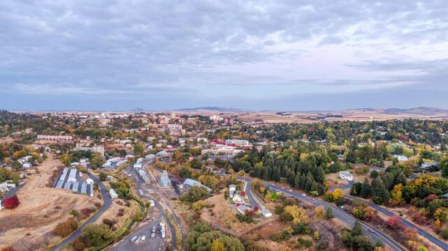 An Aerial View Of A Countryside Town Surrounded By Vibrant Autumn Foliage, Winding Roads, And Open Fields Under A Cloudy Sky, Capturing A Peaceful Small-Town Charm - Pullman, Washington