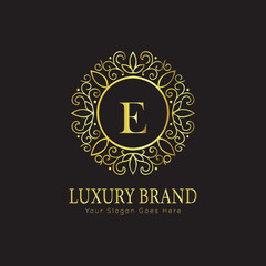 Letter Luxury brand logo design with a royal gold crown emblem and elegant typography
