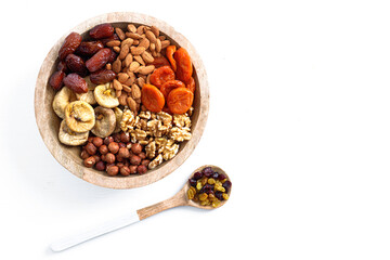 Mixed nuts and dried fruits on a plate on a white background, copy space. Symbols of the Jewish holiday of Tu Bishvat Healthy snack