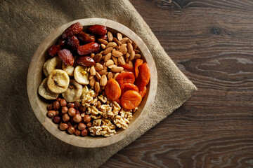Dried fruits wooden spoon on white background with copy space. Symbols of Jewish holiday Tu Bishvat. Healthy snack - mix of organic dried fruits.