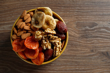 Dried fruits wooden spoon on white background with copy space. Symbols of Jewish holiday Tu Bishvat. Healthy snack - mix of organic dried fruits.
