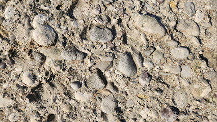 Structure of a conglomerate rock in a river bed as a design 