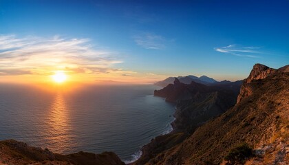 panorama of a sunset landscape of mountains and ocean