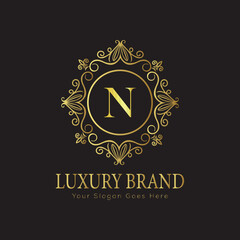 Letter Luxury brand logo design with a royal gold crown emblem and elegant typography
