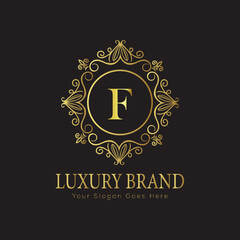 Letter Luxury brand logo design with a royal gold crown emblem and elegant typography
