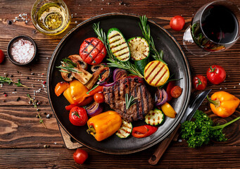 A vibrant flat-lay of a gourmet meal, including colorful vegetables, perfectly grilled meat, and a...