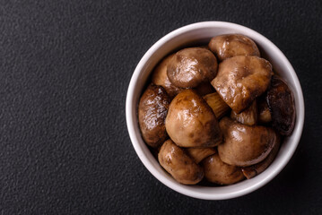 Fototapeta premium Grilled champignon mushrooms with salt, spices and herbs