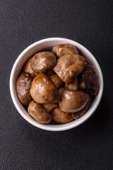 Grilled champignon mushrooms with salt, spices and herbs
