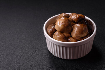Grilled champignon mushrooms with salt, spices and herbs