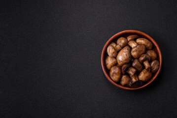 Grilled champignon mushrooms with salt, spices and herbs