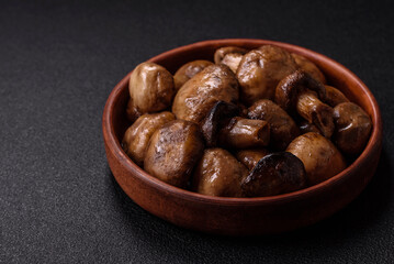 Grilled champignon mushrooms with salt, spices and herbs
