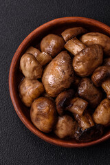 Grilled champignon mushrooms with salt, spices and herbs