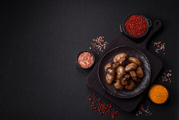 Grilled champignon mushrooms with salt, spices and herbs