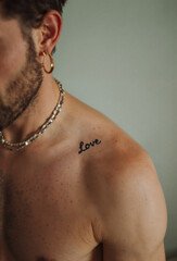 Fototapeta premium Small Love Tattoo on Collarbone for Men