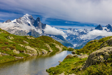 Obraz premium Lake in the Alps. Beautiful clear turquoise water lake in Chamonix Mont Blanc valley in French Alps. Alpine beautiful scenery in summer with blue sky