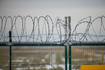 Perimeter fence crossing security for intruders to not cross its limitations. Safety of property boundaries and fence. Strong area control