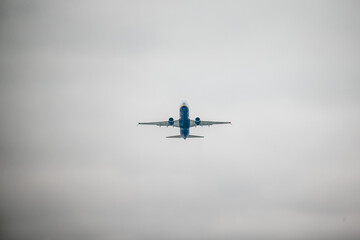 Airplane full of passengers after liftoff to warmer country flying over boarders