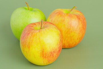 Three apples on a green background. Fruit, apple.