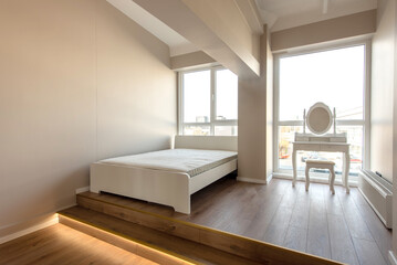Minimalist Bedroom with Elevated Wooden Platform and Bright Natural Lighting. Home Interior.