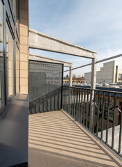 Modern Apartment Balcony Overlooking Urban Rooftops in Daylight. Home Loft Exterior. Industry Area