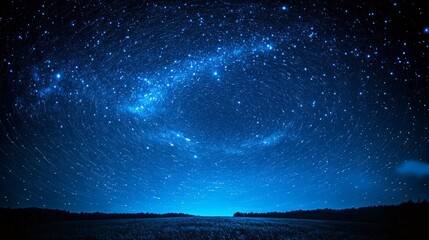 Fototapeta premium Night sky filled with star trails above a forest in peaceful twilight